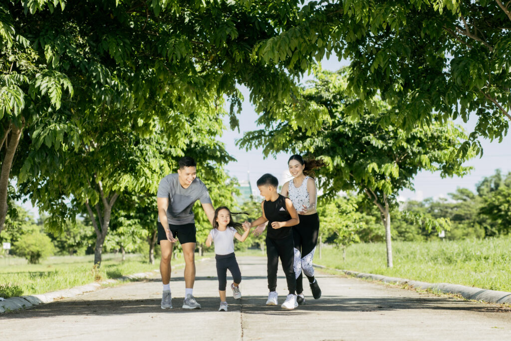 A family of four inside the open spaces in Hillsdale Subdivision