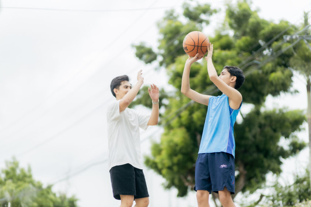 Lifestyle photo: two men playing basketball